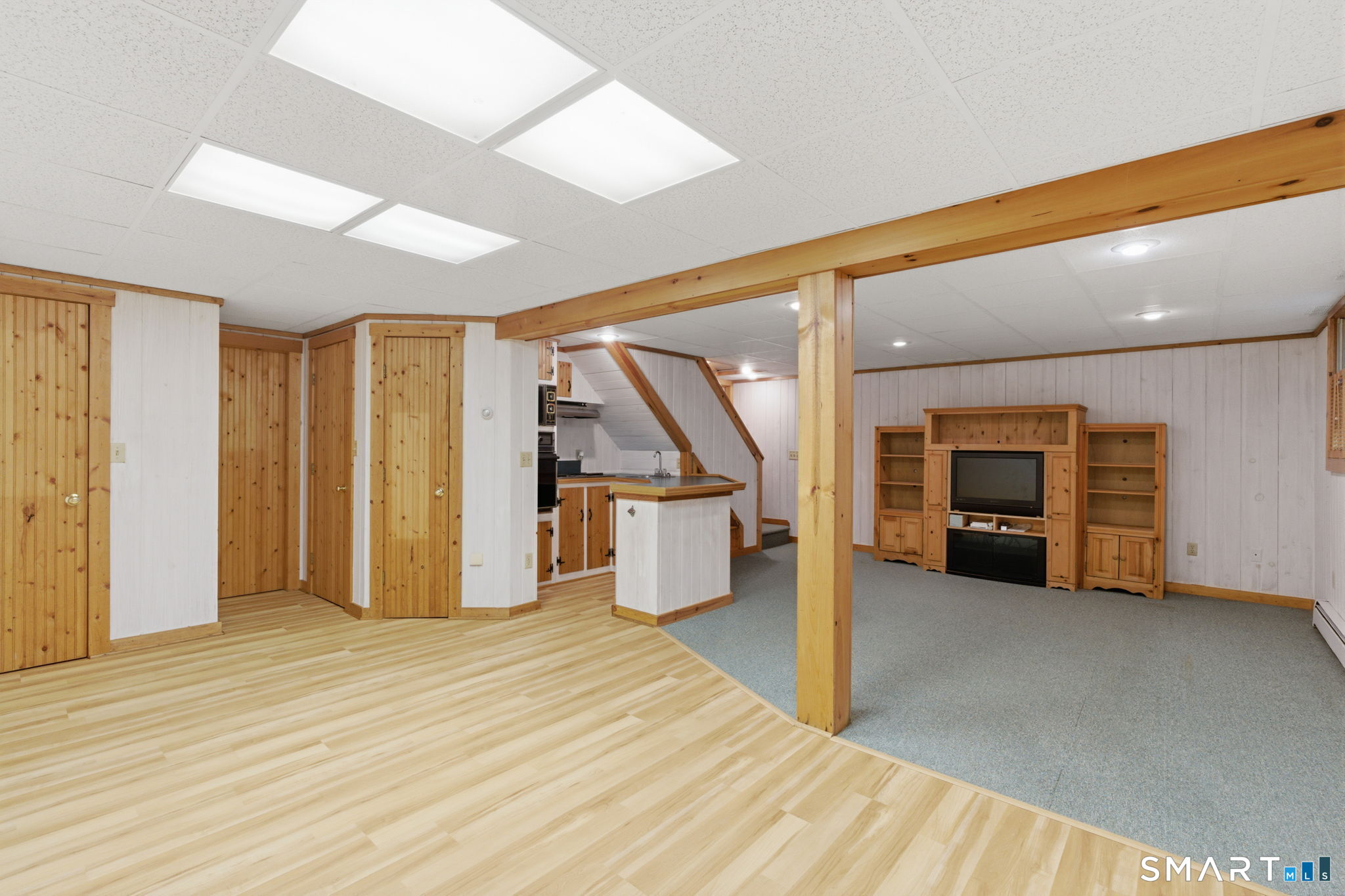 79 Buckboard Lane Bristol, CT 06010 - Photo 40 of 40 an empty room with wooden floor and way to kitchen