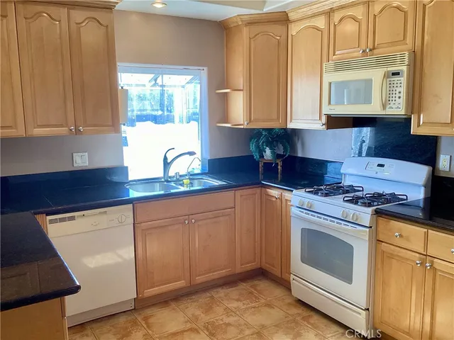 a kitchen with stainless steel appliances wooden cabinets and a table