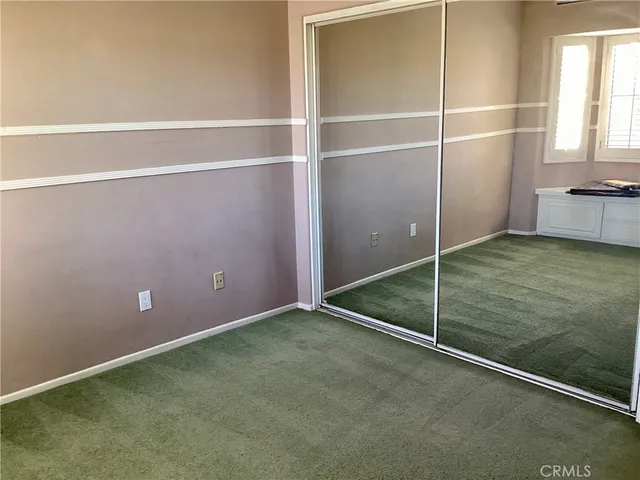 an empty room with a empty space and a window