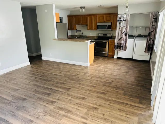 a kitchen with stainless steel appliances a refrigerator and a stove top oven