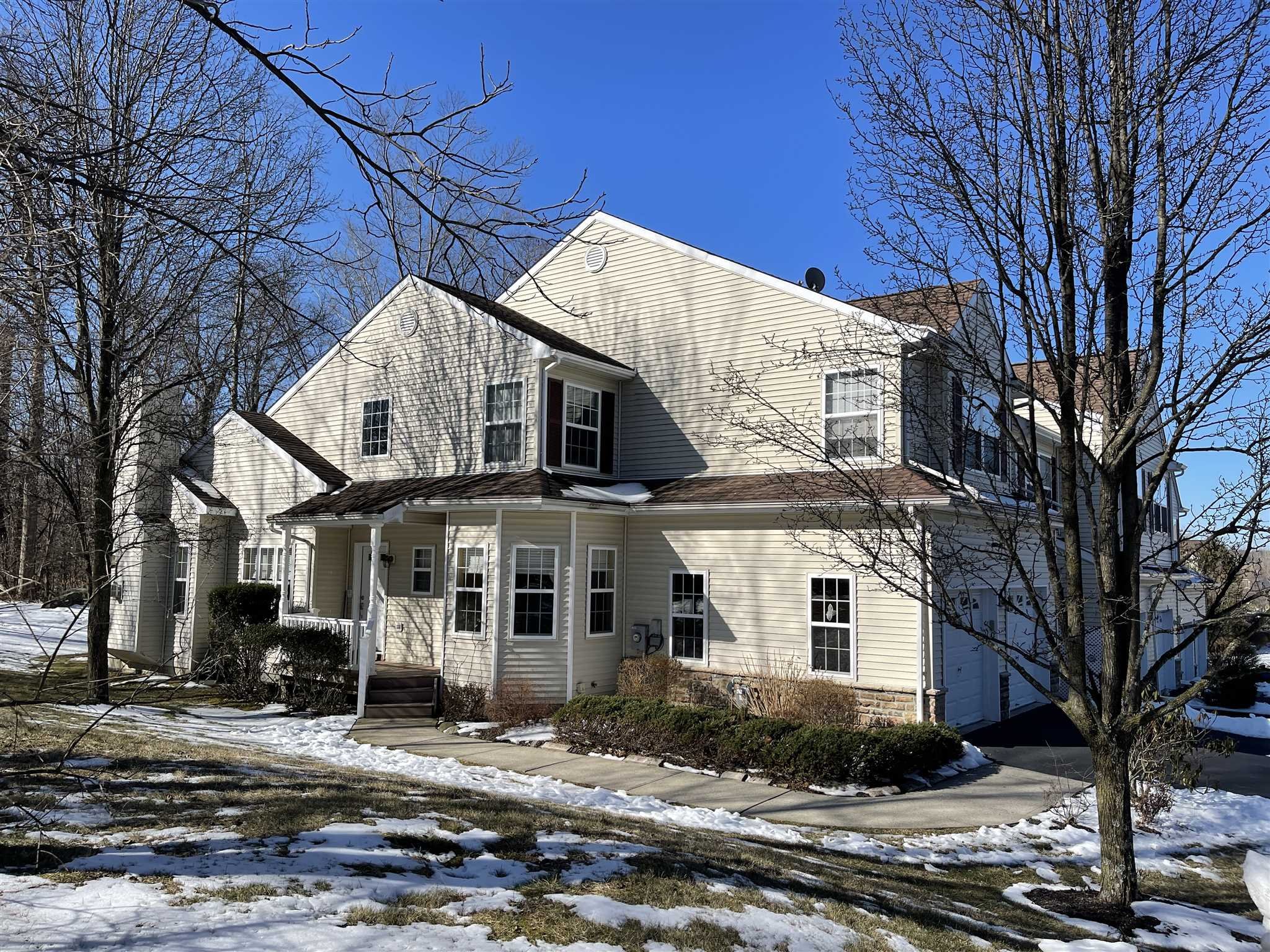 208 Pondview Loop Wappingers Falls, NY 12590 - Photo 1 of 12 a view of a white house with large windows next to a road