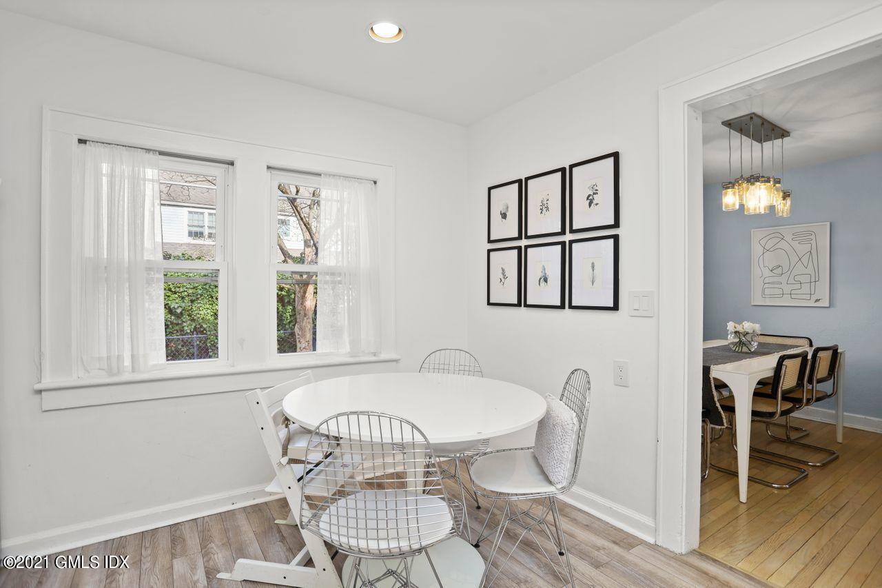 55 Oval Avenue Riverside, CT 06878 - Photo 13 of 29 a dining room with furniture a window and wooden floor