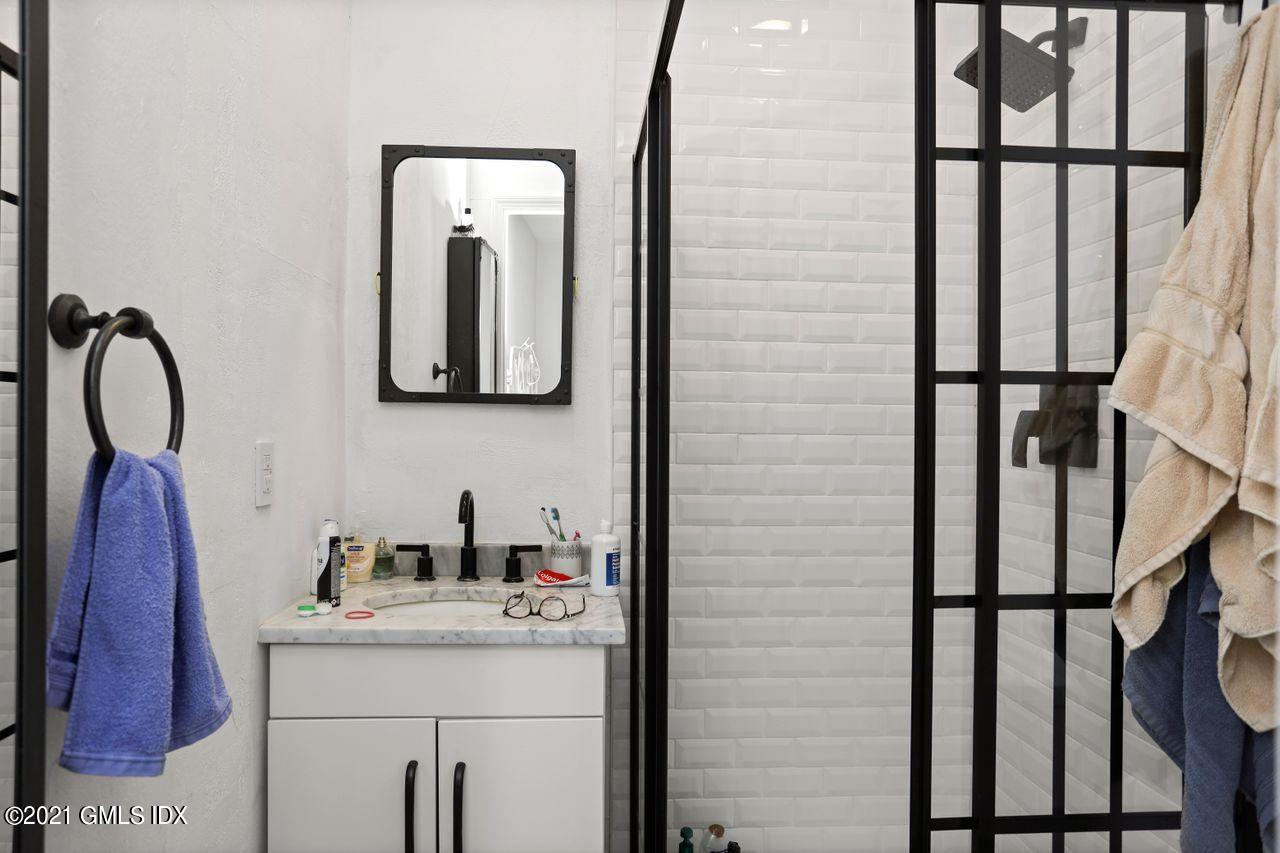 55 Oval Avenue Riverside, CT 06878 - Photo 21 of 29 a bathroom with a granite countertop shower a sink and a stove