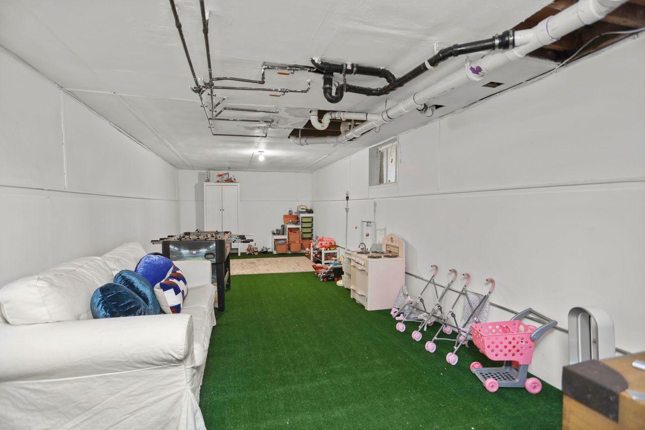 55 Oval Avenue Riverside, CT 06878 - Photo 24 of 29 a living room with lots of white furniture and a chandelier