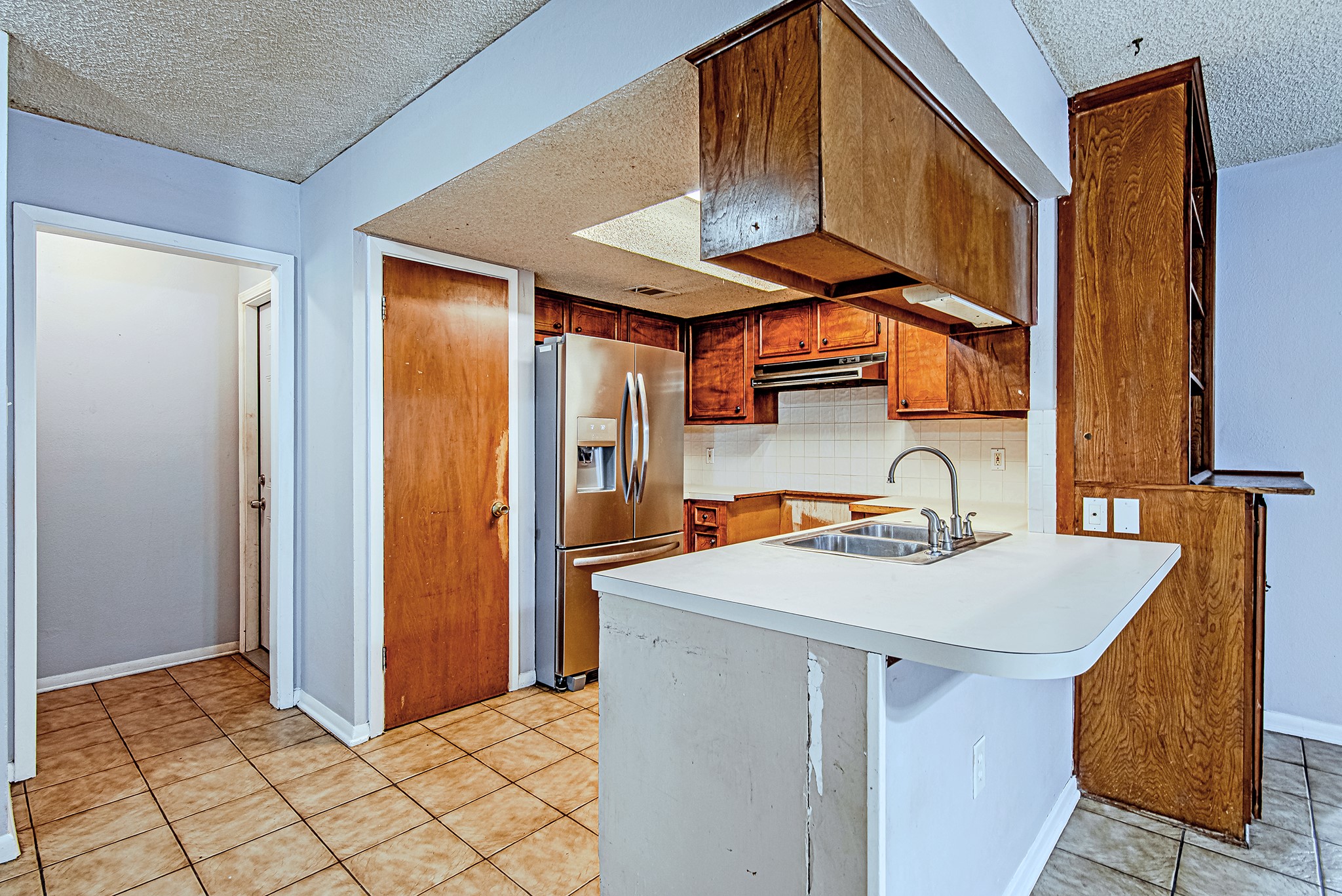 2710 Burke Road Pasadena, TX 77502 - Photo 9 of 28 Breakfast bar and open kitchen layout create a functional workspace