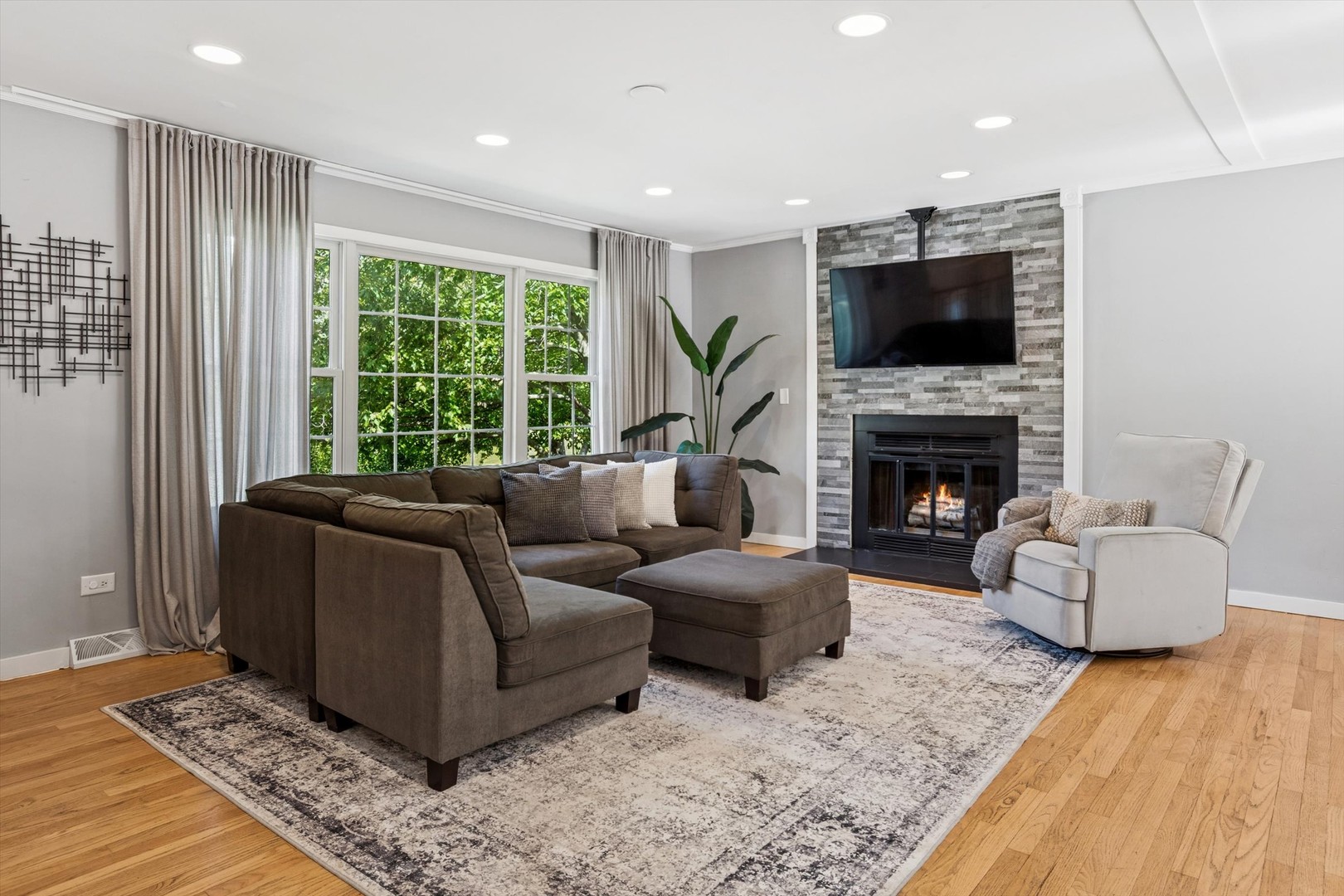 24331 Davids Court Naperville, IL 60564 - Photo 2 of 24 a living room with furniture flat screen tv and a fireplace