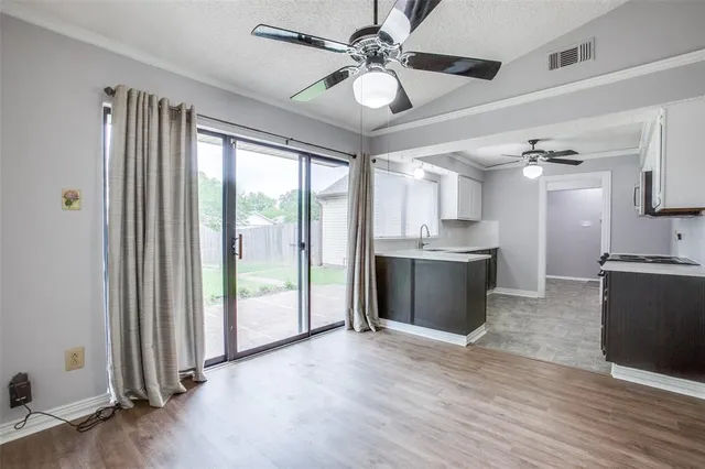 a view of a kitchen with a sink and a window