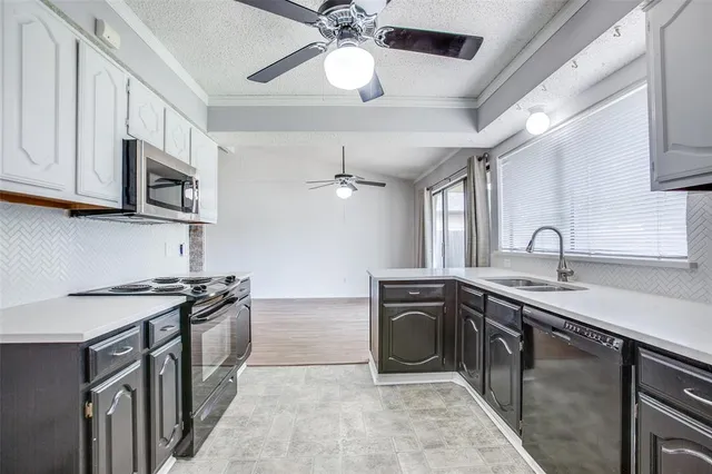 a kitchen with stainless steel appliances granite countertop a sink and stove top oven