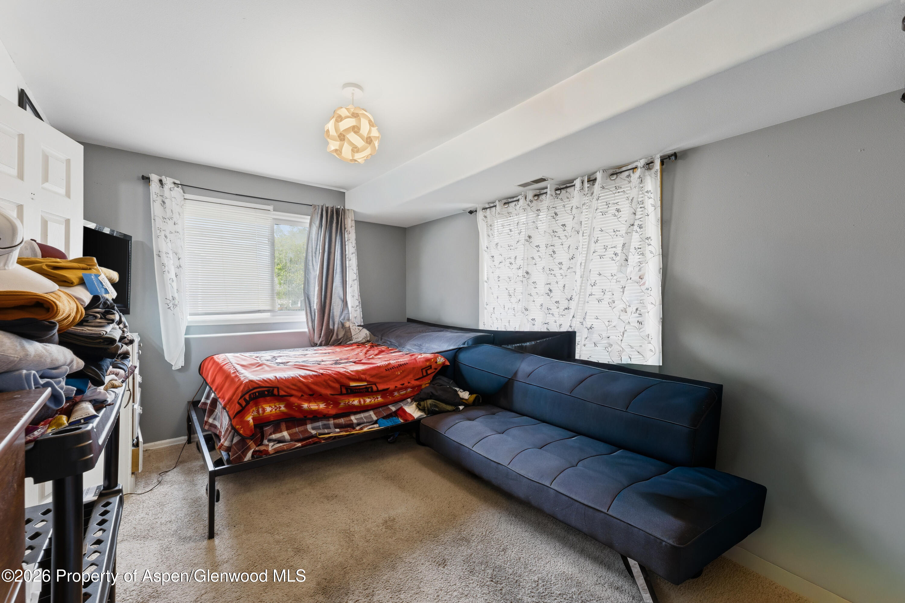 164 Current Drive New Castle, CO 81647 - Photo 17 of 34 a bedroom with a bed couch and a window