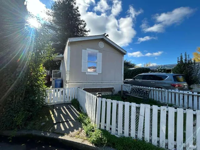 a view of street with wooden fence