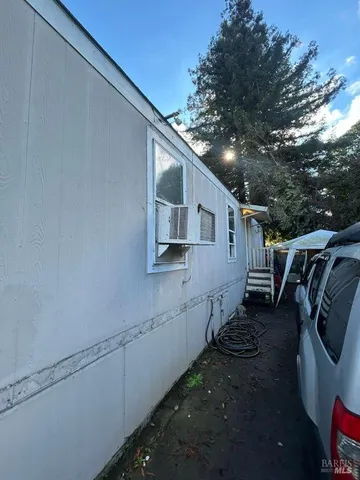 a view of a house with backyard and trees