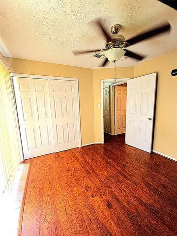 a view of a room with wooden floor