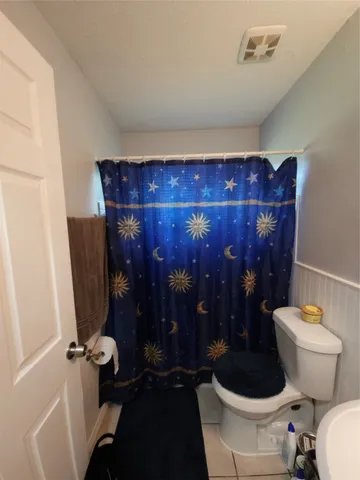 a bathroom with a toilet and a shower