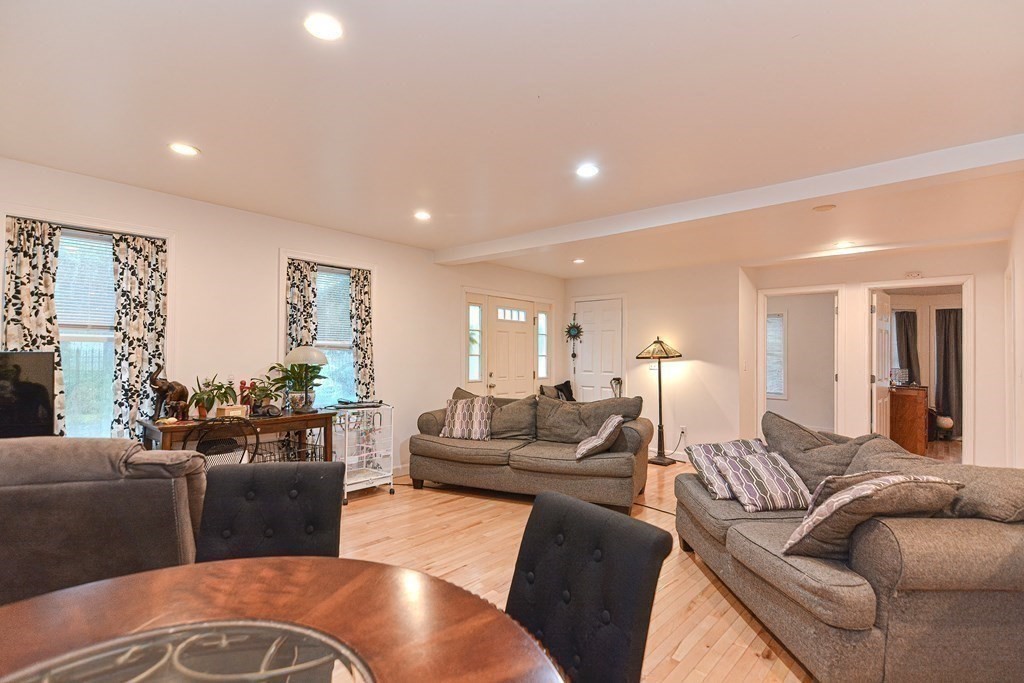 89 Broad Street, Unit 1 Lynn, MA 01902 - Photo 11 of 23 a living room with furniture wooden floor and a large window