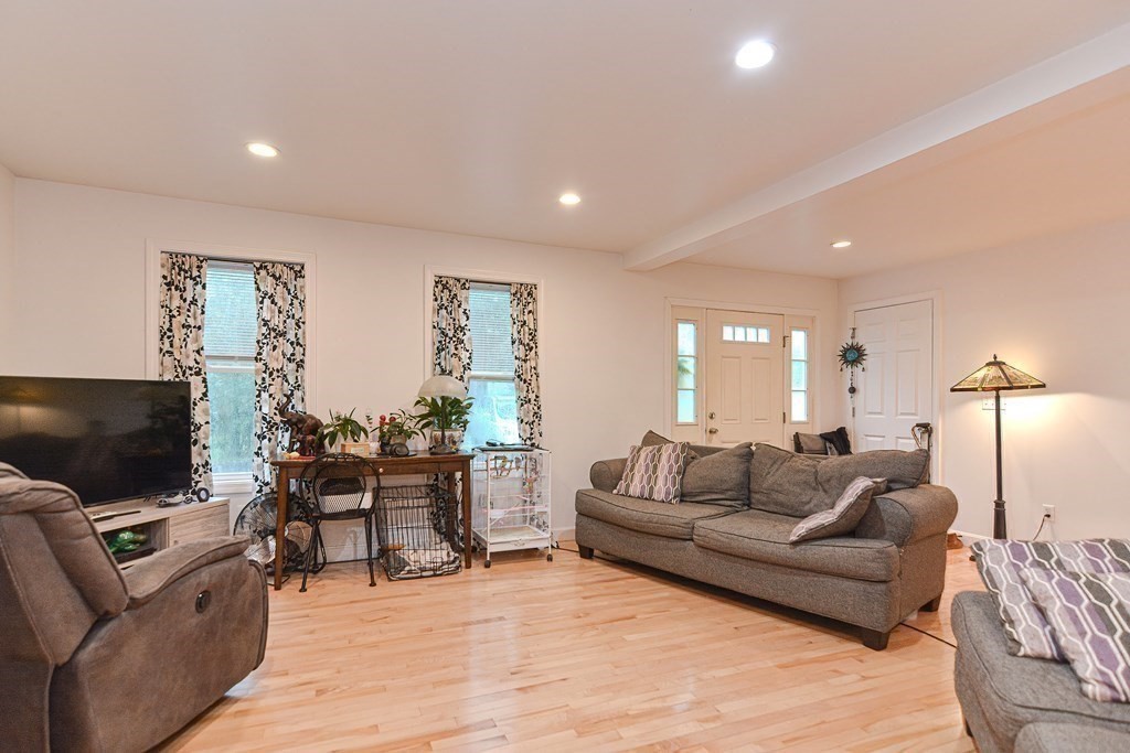 89 Broad Street, Unit 1 Lynn, MA 01902 - Photo 12 of 23 a living room with furniture and a flat screen tv