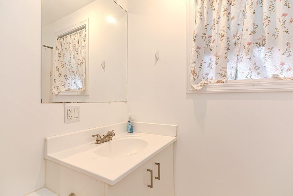 89 Broad Street, Unit 1 Lynn, MA 01902 - Photo 14 of 23 a bathroom with a sink and a mirror