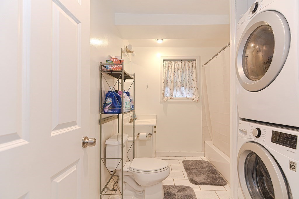 89 Broad Street, Unit 1 Lynn, MA 01902 - Photo 15 of 23 a view of a bathroom with washing machine and sink