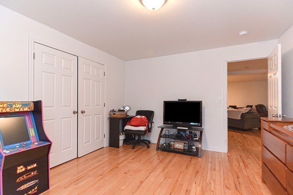 89 Broad Street, Unit 1 Lynn, MA 01902 - Photo 20 of 23 a living room with furniture and a flat screen tv