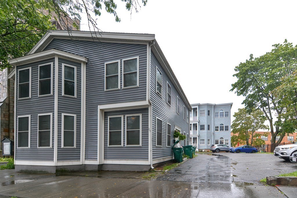 89 Broad Street, Unit 1 Lynn, MA 01902 - Photo 22 of 23 a front view of a house with a yard