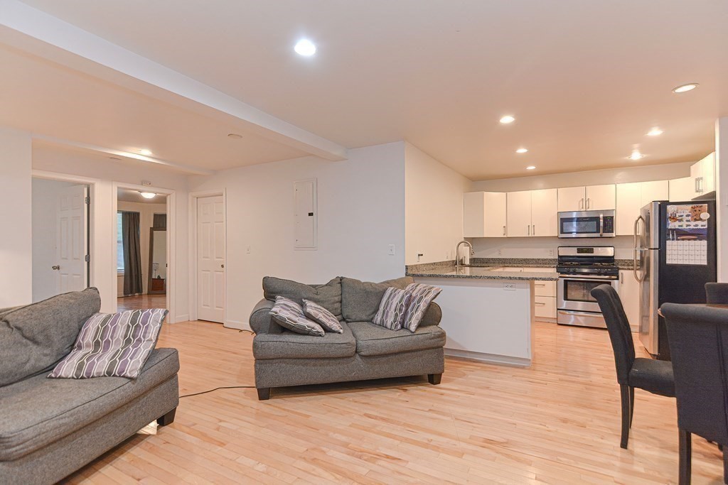 89 Broad Street, Unit 1 Lynn, MA 01902 - Photo 8 of 23 a living room with furniture and kitchen view