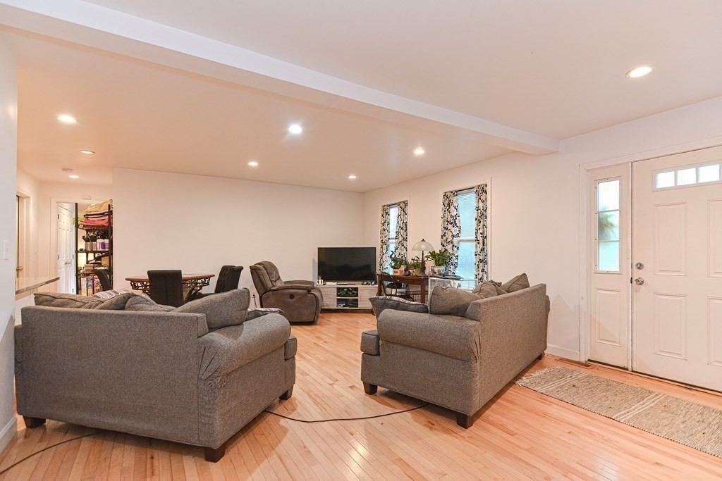 89 Broad Street, Unit 1 Lynn, MA 01902 - Photo 10 of 23 a living room with furniture and a flat screen tv