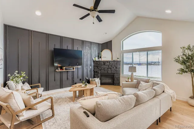 a living room with furniture a fireplace and a flat screen tv