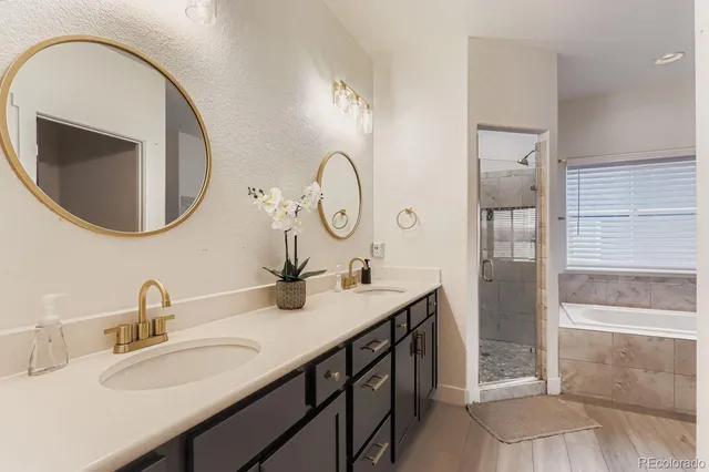 a bathroom with a double vanity sink and a mirror