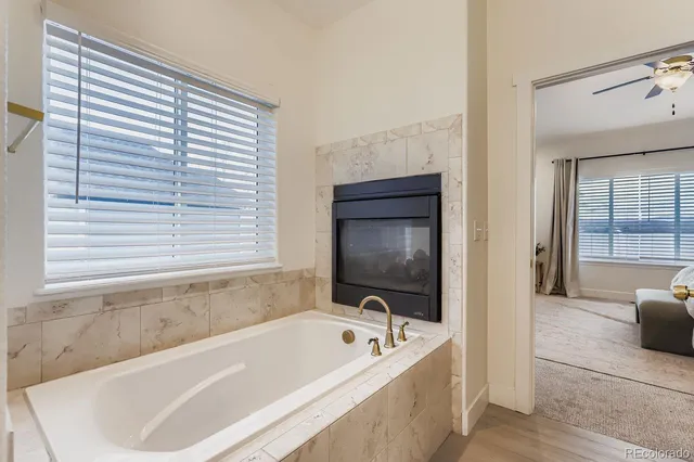 a bath tub sitting in a bathroom next to a window