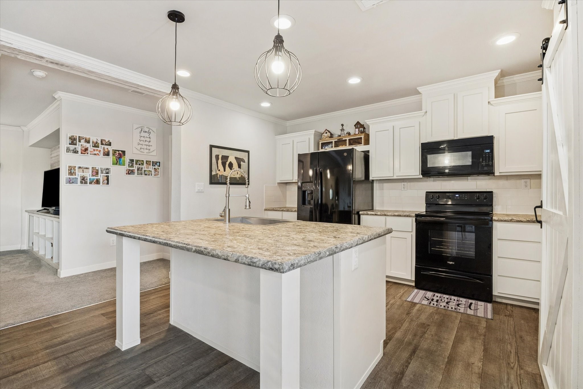 8850 Katy Hockley Road Katy, TX 77493 - Photo 16 of 37 a kitchen with kitchen island a counter space a sink appliances and cabinets
