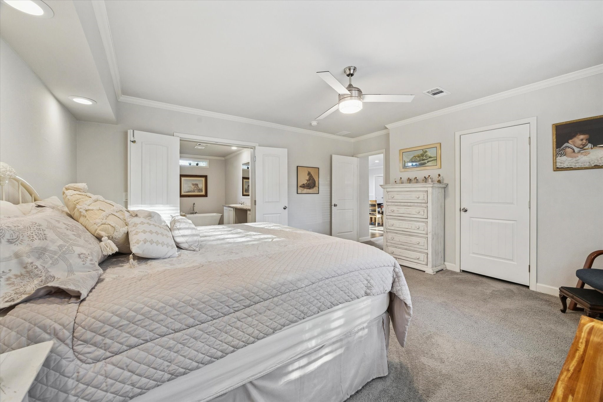 8850 Katy Hockley Road Katy, TX 77493 - Photo 20 of 37 a spacious bedroom with a large bed and a chandelier