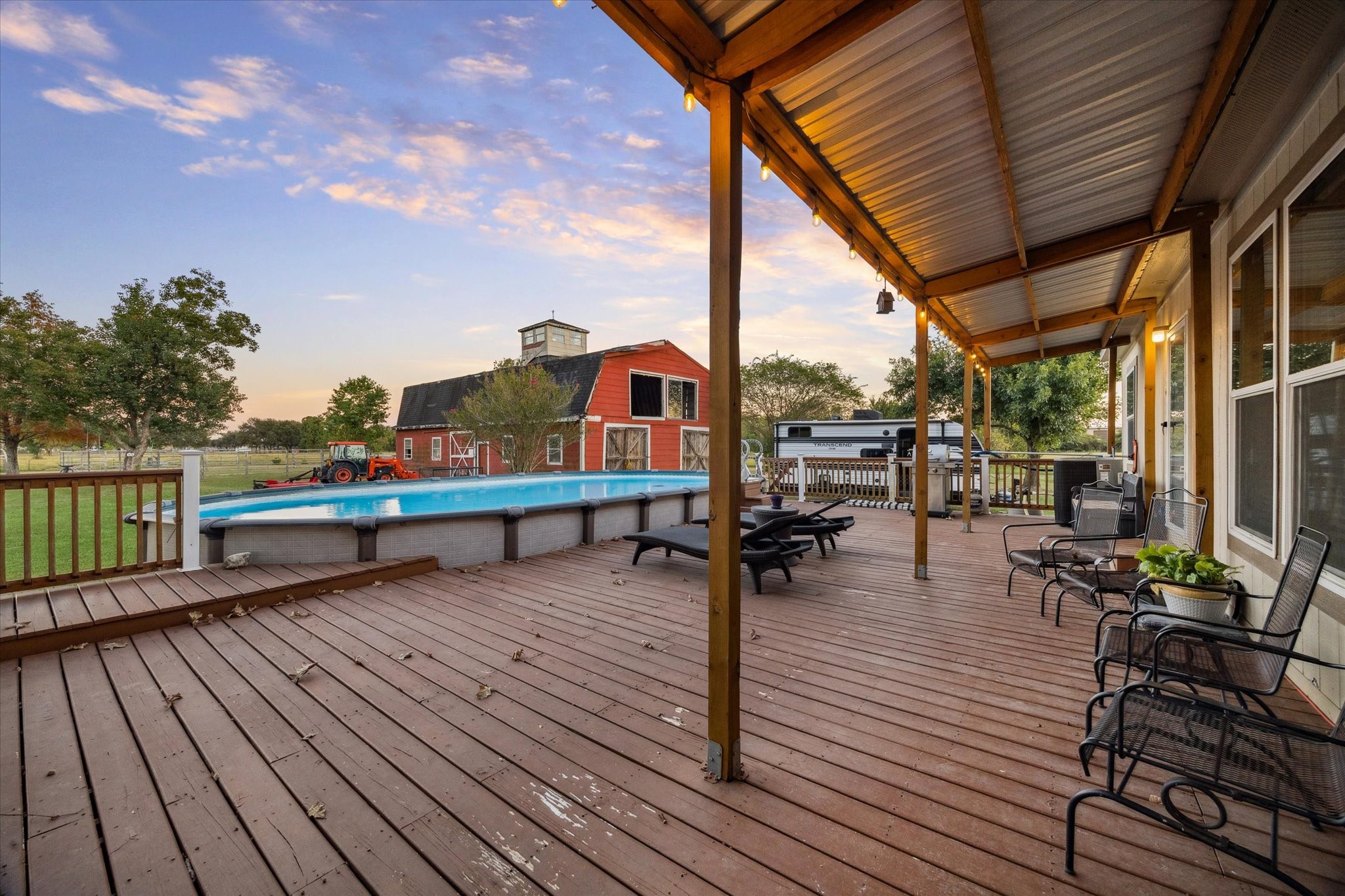 8850 Katy Hockley Road Katy, TX 77493 - Photo 28 of 37 a park on wooden deck with table and chairs a barbeque with wooden floor and fence