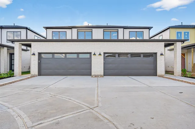 a front view of a house with a garage and a garage
