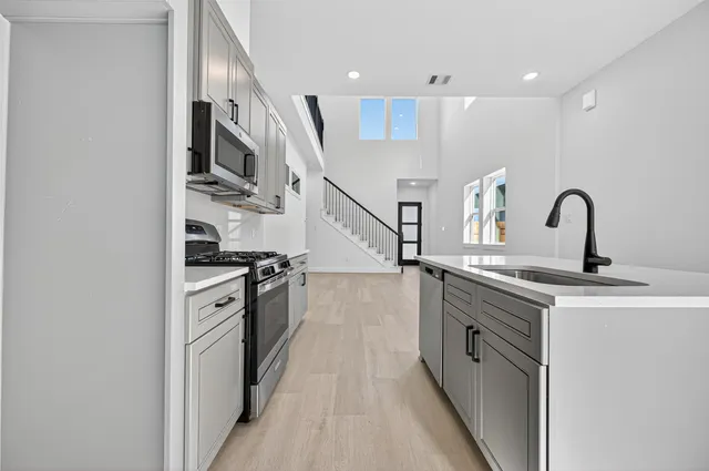 a kitchen with stainless steel appliances granite countertop a sink and cabinets