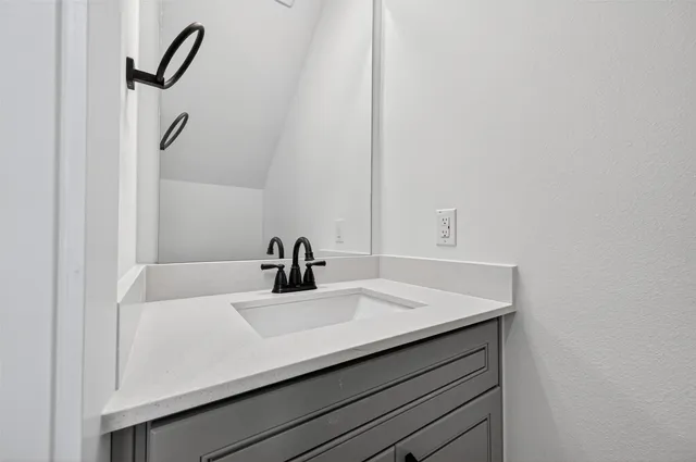 a bathroom with a sink and a mirror
