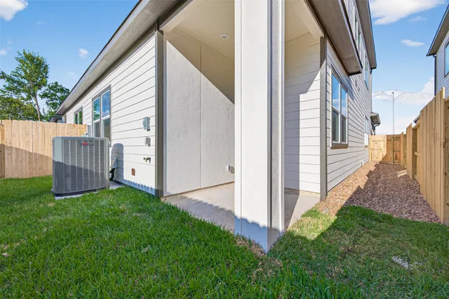 a view of backyard of house with green space
