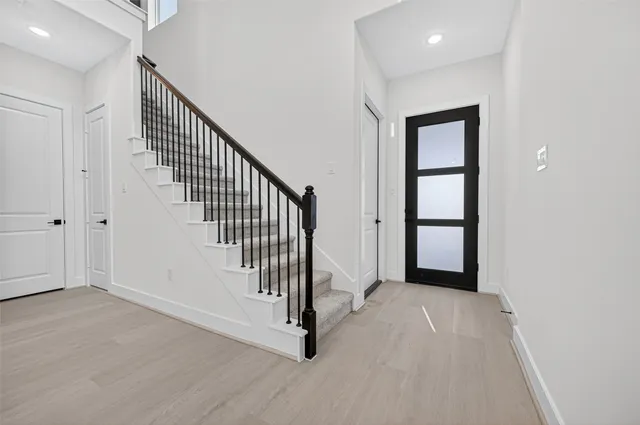 a view of an entryway with wooden floor
