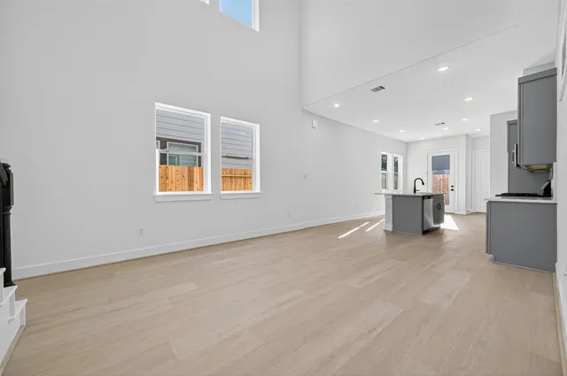a view of a kitchen with a sink and a refrigerator