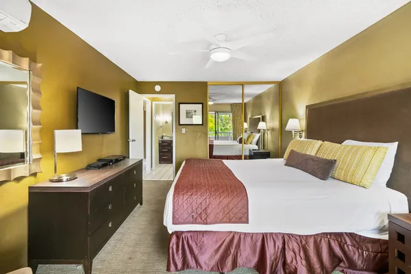 a bed room with a bed and a large mirror