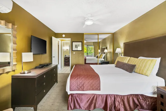 a bed room with a bed and a large mirror