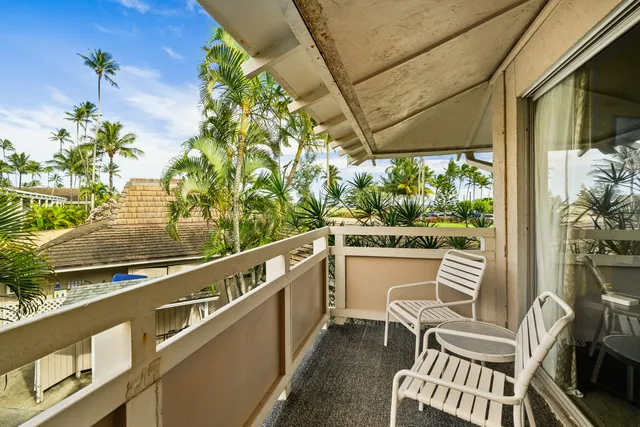 a view of a chairs and table in the balcony
