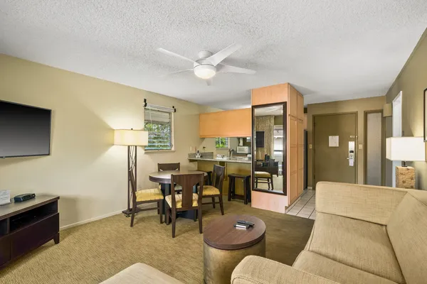 a living room with furniture a chandelier and a dining table