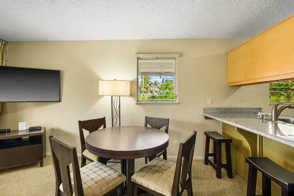 a view of a dining room with furniture and a potted plant