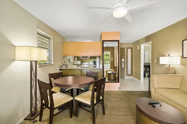a dining room with furniture and a chandelier