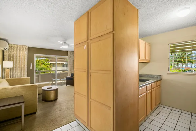 a kitchen with a refrigerator and a sink