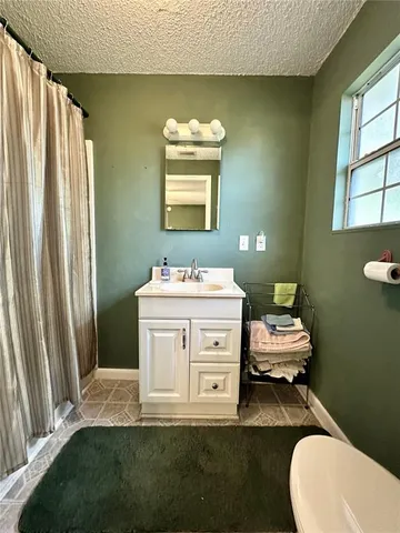 a bathroom with a sink mirror and toilet