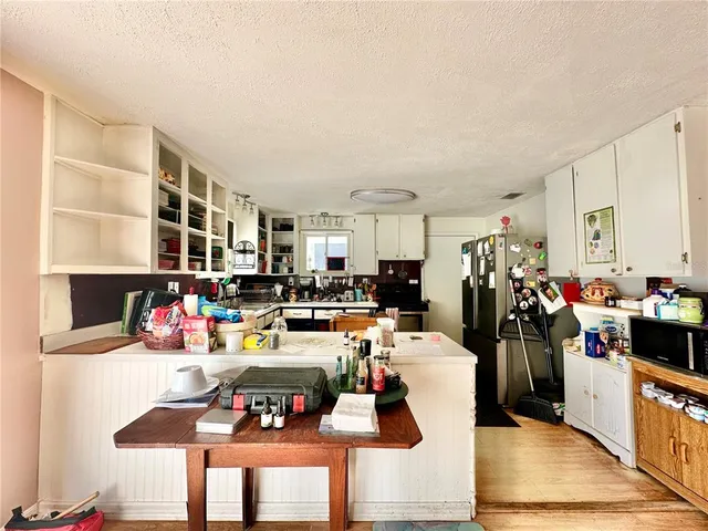 a living room with lots of furniture and clutter