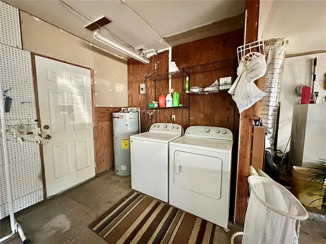 a view of a storage and utility room with washer and dryer