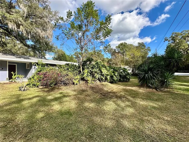 a view of a house with a tree in a yard