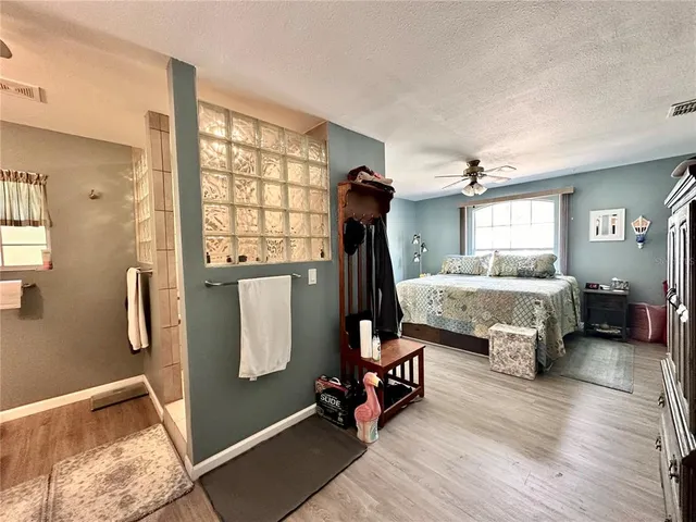 a bedroom with furniture and a window