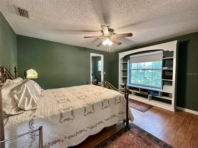 a bedroom with a bed and large window